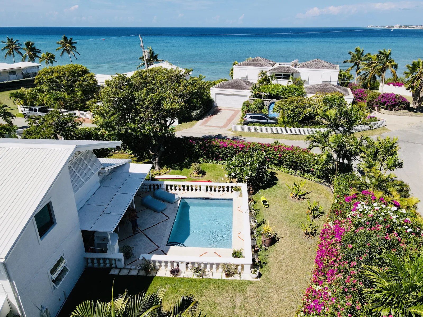 Sundance from above: the pool with its white balustrade, the garden full of bougainvillea and the sea behind
