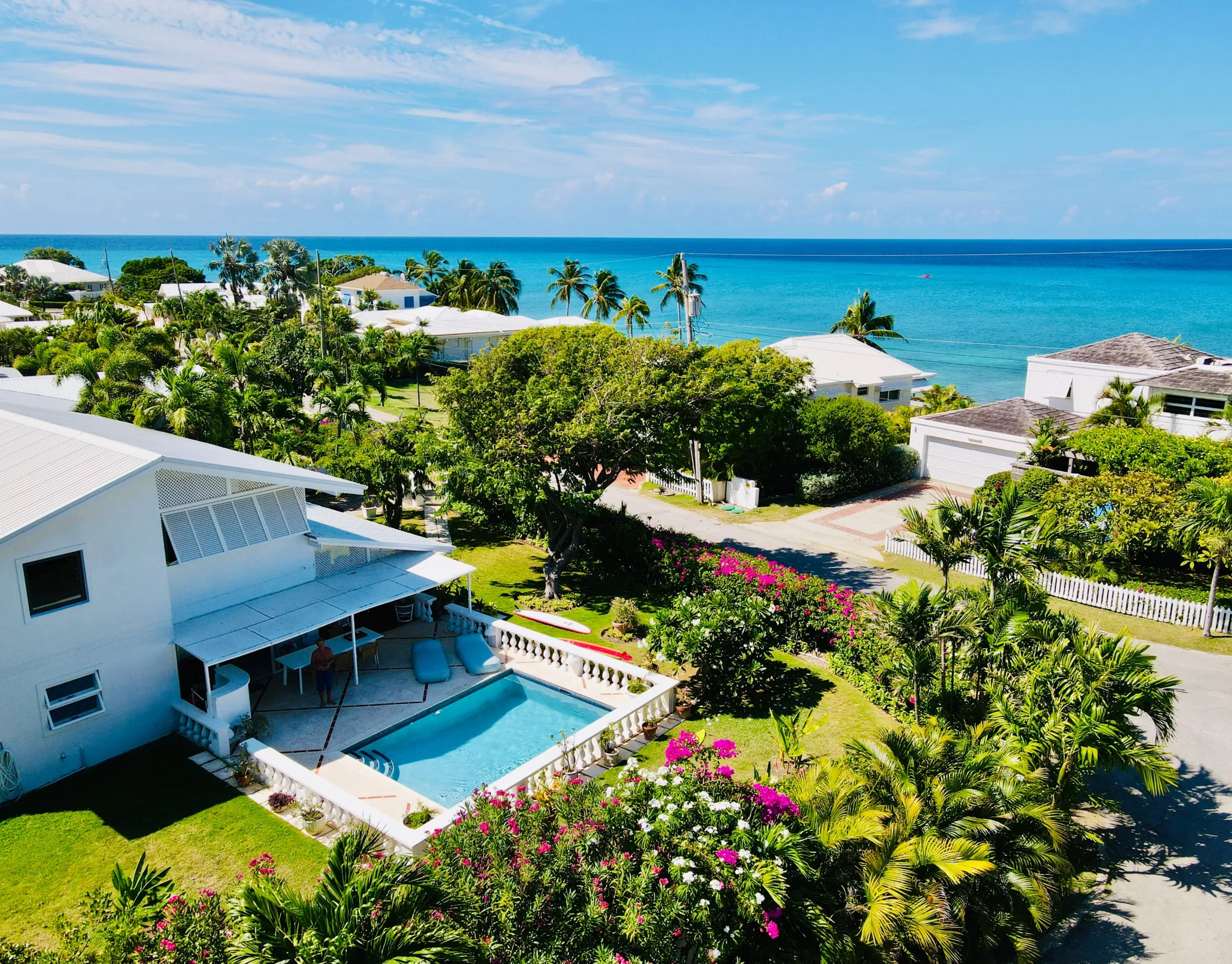 Sundance from the air: the pool, the garden with bougainvillea and the turquoise sea behind