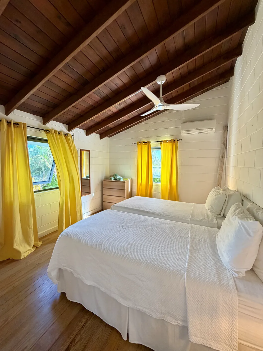 The yellow bedroom with yellow curtains and a view outside